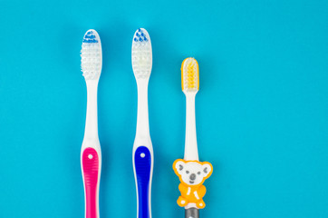 Toothbrushes on blue background. Copy space for text
