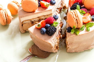 homemade cake with macaron and fresh fruit, berries, mint on a light background