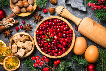 Christmas food baking background top view on black background.