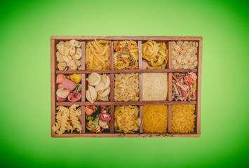 Box with different uncooked pasta, top view. Stodio photo shooting