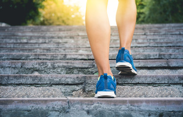 Fitness woman running up the old stairs. Legs running and burn out fat for fit body, Healthy and...