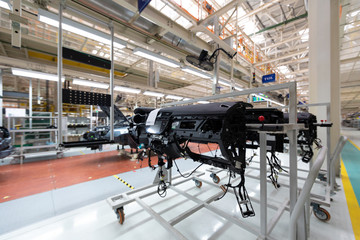 Add details to car body. Robotic equipment makes Assembly of car. Modern car Assembly at factory