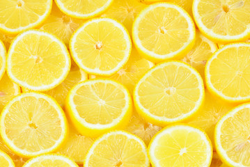 A slices of fresh juicy yellow lemons.  Texture background, pattern.