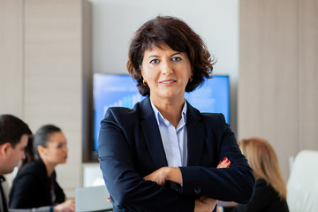 Middle aged business woman in conference room. Woman suit.