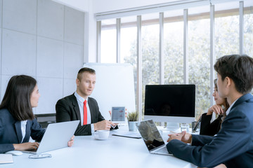 Young business people are presented marketing work project to the customer in meeting room office
