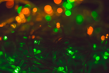 Christmas background with warm green lights and copy space. Background with christmas lights. Christmas garland.