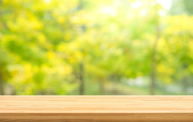 Real wood table top texture on leaf tree garden background.For create product display or design key visual