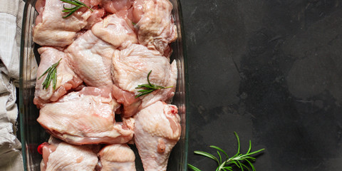 chicken crude pieces - raw meat (dark background). top view. to copy space © Alesia Berlezova