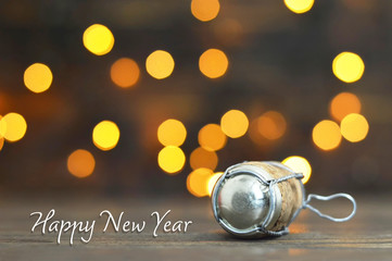 Happy New Year card. Champagne cork on wooden background