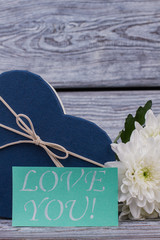 Gift, flowers and love message. Valentine holiday background with gift and blooming flowers. Love and romance.