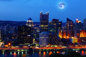 Fototapeta na wymiar Rising moon above Pittsburgh, Pennsylvania