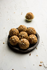 Oats laddu or Ladoo also known as Protein Energy balls. served in a plate or bowl. selective focus