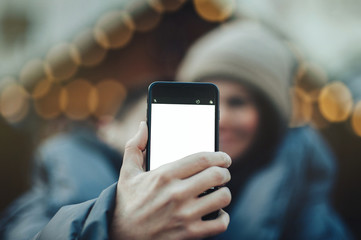 Young romantic couple is having fun outdoors in winter before Ch  