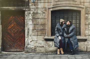 Winter holidays. Young beautiful happy smiling couple posing on   