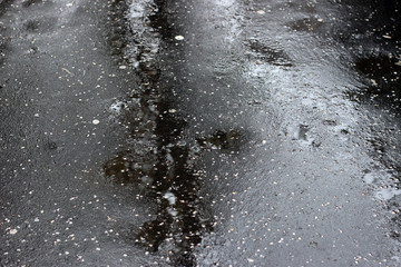 Wet asphalt pavement rain puddle