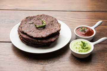 Ragi roti or flat Bread made using finger millet is a healthy and tasty breakfast dish of Karnataka, India. served with green chilli and chutney. selective focus
