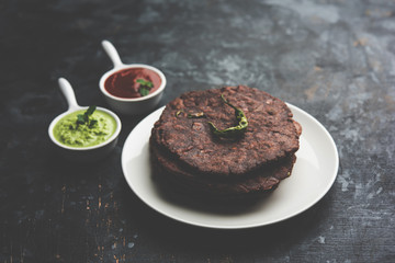 Ragi roti or flat Bread made using finger millet is a healthy and tasty breakfast dish of Karnataka, India. served with green chilli and chutney. selective focus