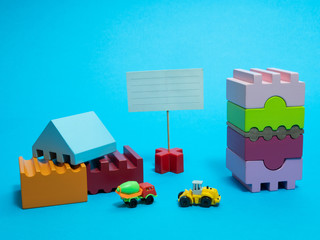 construction site with vivid colorful wooden blocks child toy, truck, concrete mixer and small sign...