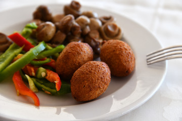 Potato balls and Fried mushrooms on plate