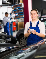 Girl mechanic taking notes on notebook