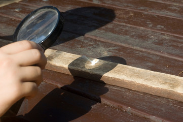 burning wood with Magnifying glass