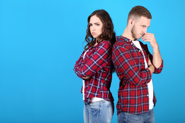 Beautiful young couple on blue background