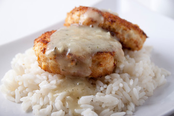 Fish Cutlets with sauce and rice garnish