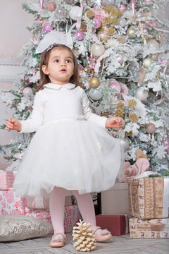 Little child girl and Christmas tree