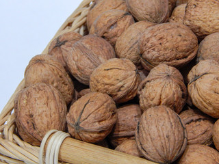Walnuts in a basket on a white background