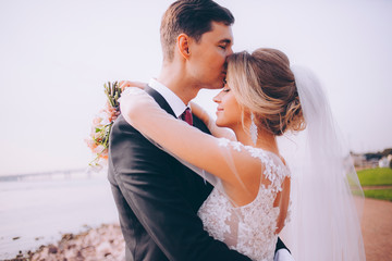 Bride and groom embrace each other on their wedding day