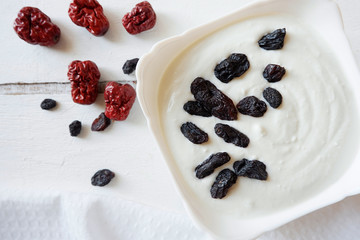 PP cottage cheese on a white background with raisins and jujube