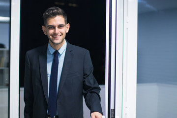 business man opening the front door