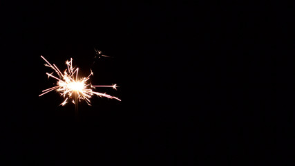 Christmas eve. Dark background. Bengal lights, sparklers.