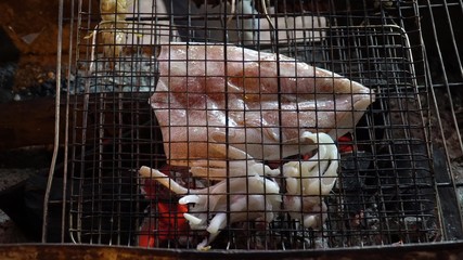 Restaurant buffet sea food. Squid is grilled.