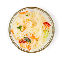 Funchoza salad in a glass plate on a white. The view from the top.