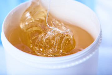 A pack of stretchy golden luminous sugaring paste, close-up