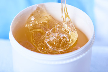 A pack of stretchy golden luminous sugaring paste, close-up