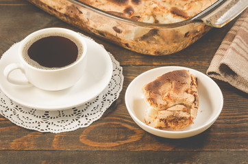breakfast with apple pie and a cup of black coffee/breakfast with apple pie and a cup of black coffee on a wooden background, selective focus
