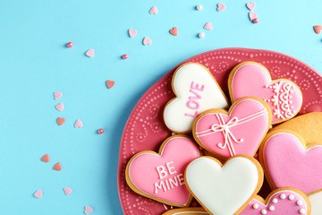 Composition with decorated heart shaped cookies and space for text on color background, top view