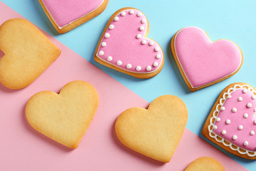 Naklejka na ściany i meble Decorated heart shaped cookies on color background, top view