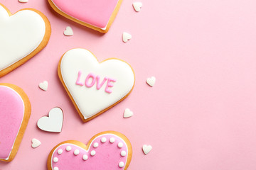 Composition with decorated heart shaped cookies and space for text on color background, top view....