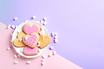 Composition with decorated heart shaped cookies and space for text on color background, top view