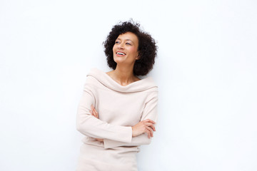 middle age woman smiling with arms crossed against white background
