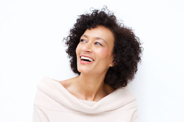 Close up attractive middle age african american woman laughing against white background