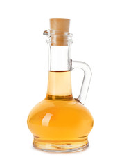Glass jug of apple vinegar on white background