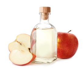 Glass bottle of vinegar and fresh apples on white background