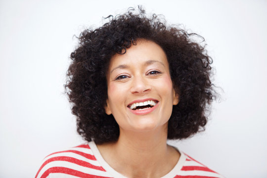 Front Portrait Of And Older African American Woman Laughing Against White Background