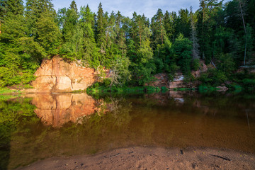 Fototapeta na wymiar beautiful sandstone cliffs on the shores of river Amata in Latvia