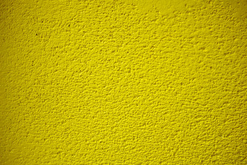 The texture of plastered golden or goldenrod wall, background