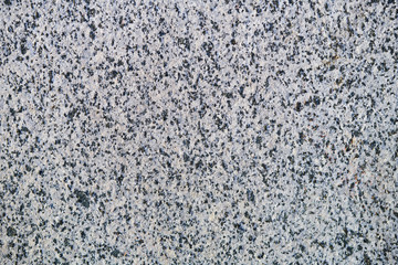 The textured grey marble chips wall, background